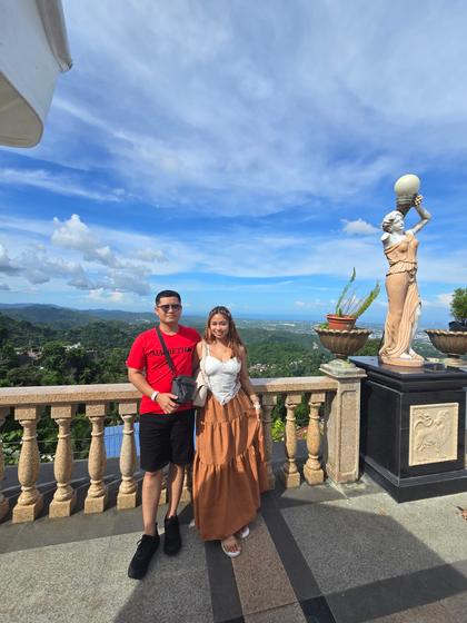 Rica Mae and Mark Lino standing together on a stone terrace overlooking the hills